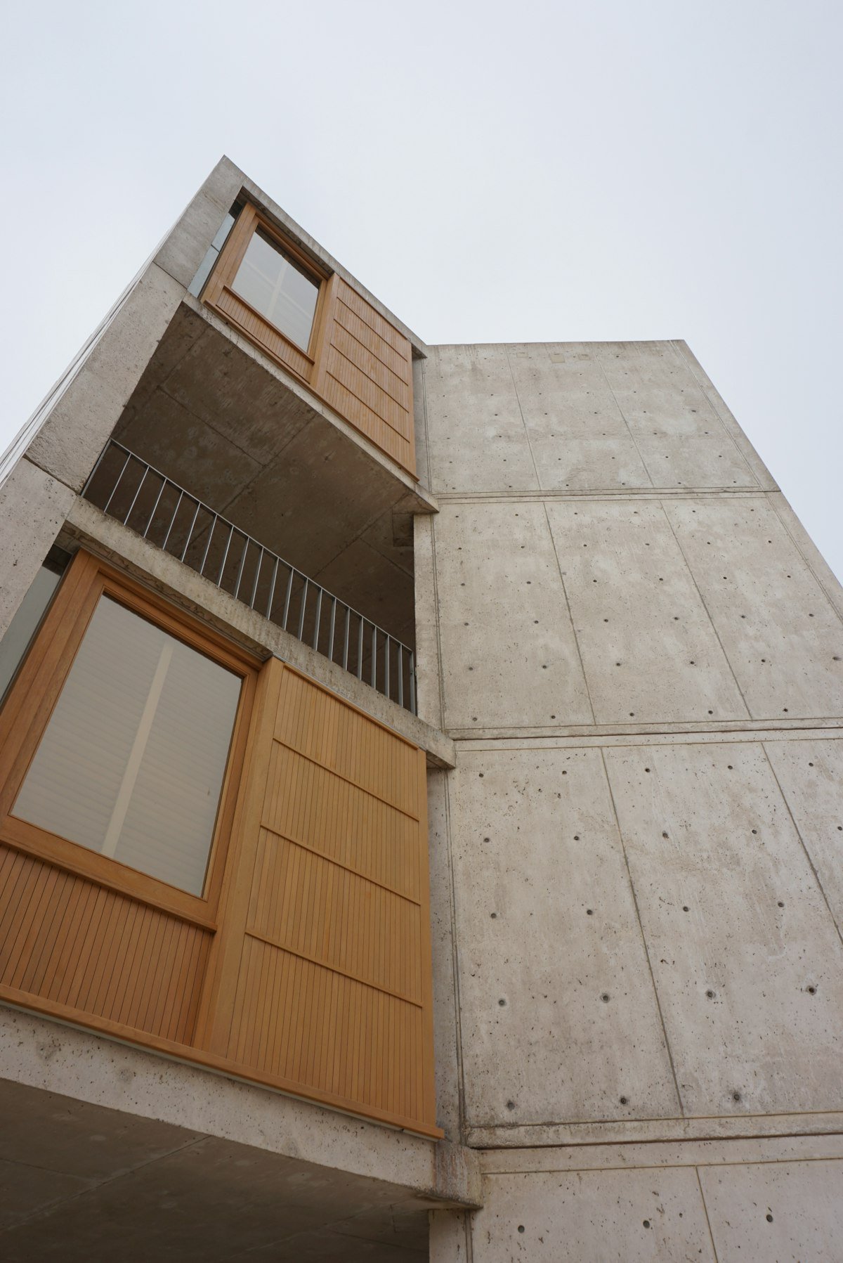 Angle de façade en béton brut et bardage bois
